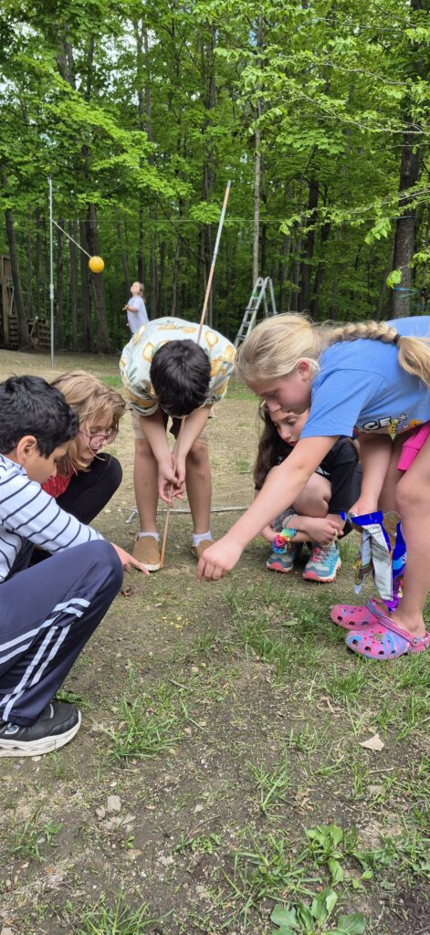 Children participating in our social skills program for kids, practicing teamwork and peer interaction skills during outdoor group activity.